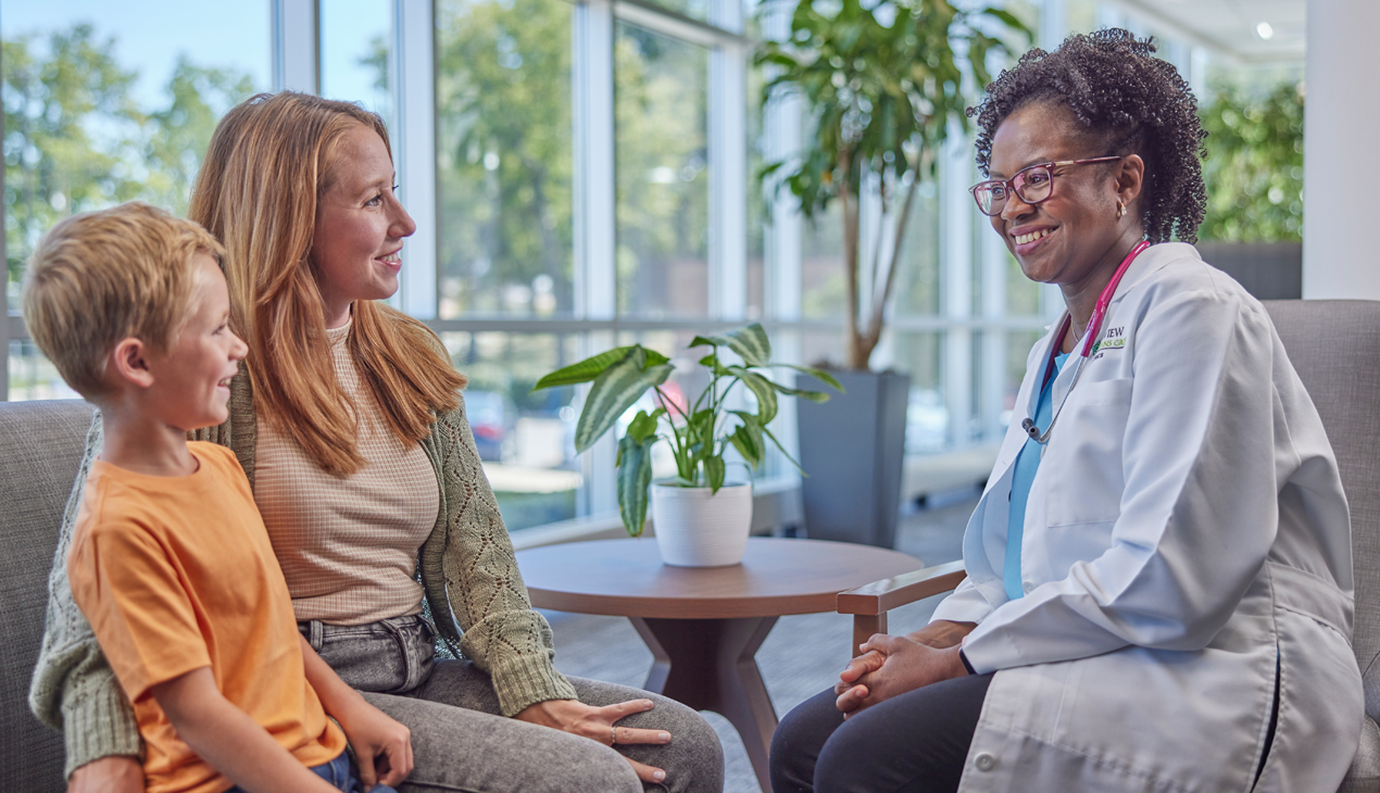provider smiling at mother and son
